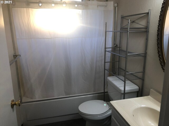 full bathroom with shower / tub combo, vanity, and toilet