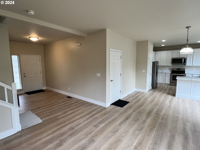 unfurnished living room with light hardwood / wood-style flooring