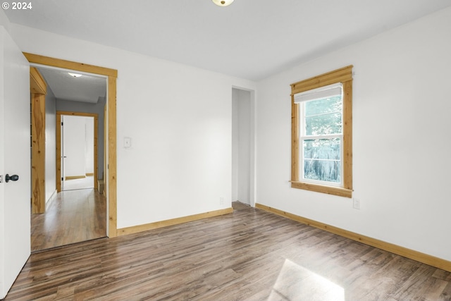 unfurnished room with wood-type flooring