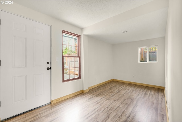 entryway featuring light hardwood / wood-style floors and a textured ceiling