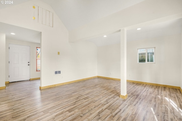 empty room with light hardwood / wood-style floors and plenty of natural light