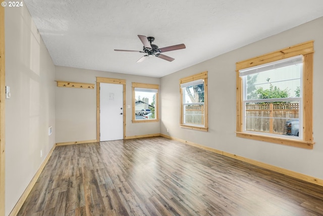 spare room featuring hardwood / wood-style floors, a textured ceiling, and ceiling fan