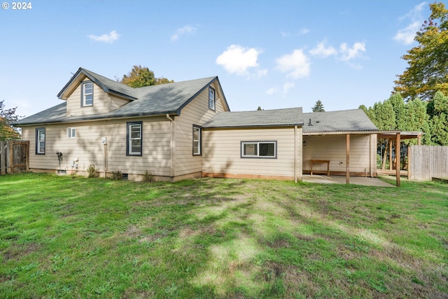 rear view of property with a yard and a patio area