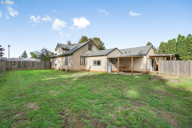 back of property featuring a yard and a patio