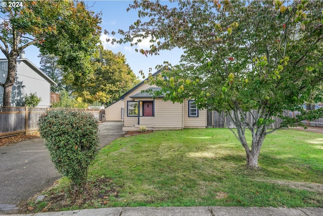 obstructed view of property with a front yard