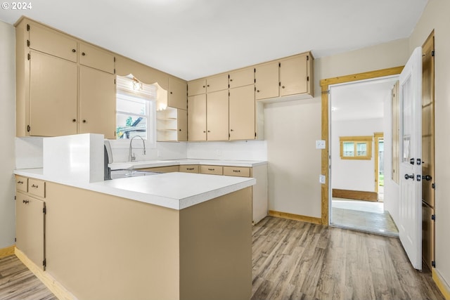 kitchen featuring kitchen peninsula and light wood-type flooring