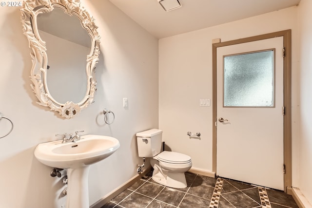 bathroom featuring tile patterned floors, toilet, and sink