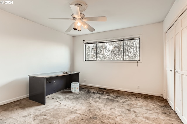 carpeted office featuring ceiling fan