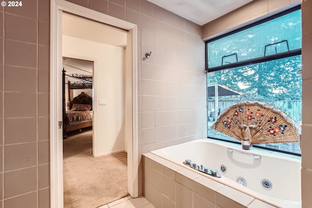 bathroom featuring a relaxing tiled tub and tile patterned floors