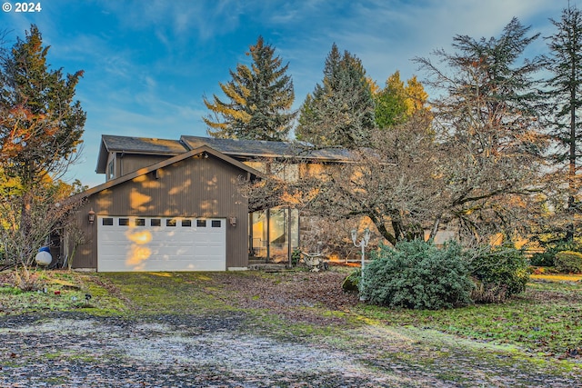 view of side of home featuring a garage