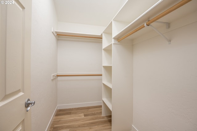 spacious closet with wood finished floors