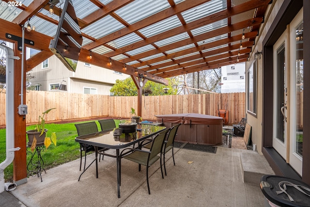 view of patio with outdoor dining area, a pergola, a hot tub, and a fenced backyard