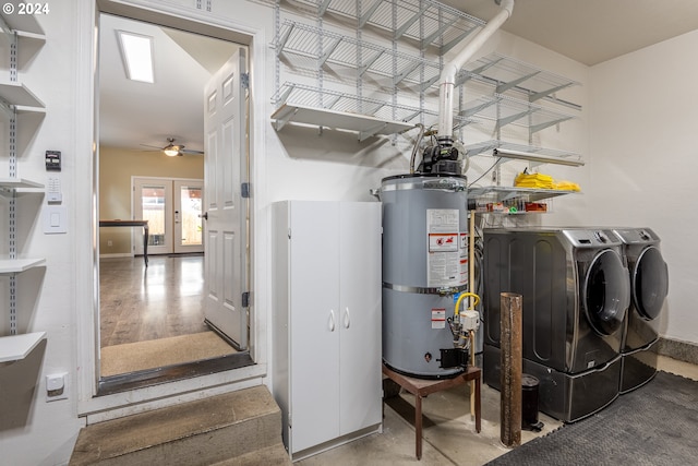 clothes washing area featuring secured water heater, french doors, ceiling fan, separate washer and dryer, and wood-type flooring