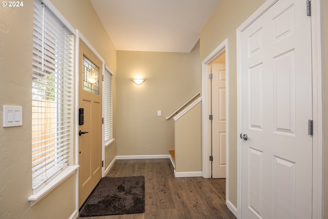 entryway featuring baseboards and wood finished floors