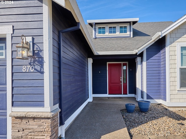 property entrance with roof with shingles