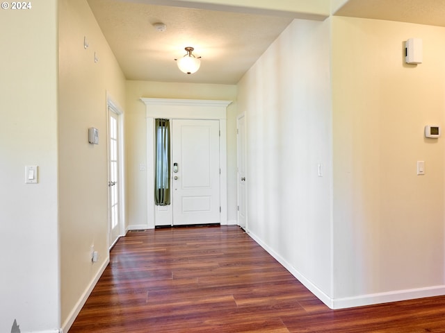 entrance foyer featuring dark wood-style floors and baseboards