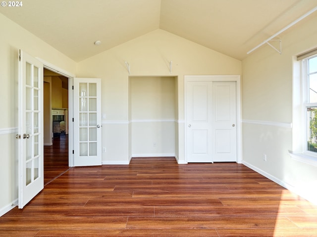 interior space featuring a closet, french doors, vaulted ceiling, and wood finished floors