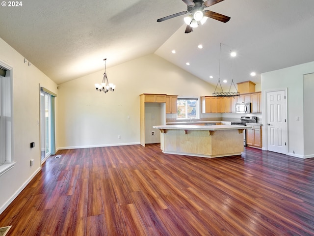 kitchen featuring a center island, light countertops, appliances with stainless steel finishes, dark wood-type flooring, and ceiling fan with notable chandelier