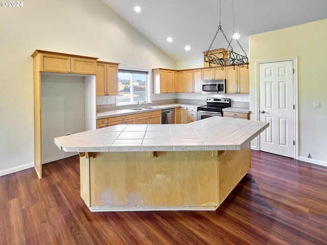 kitchen with a kitchen island, dark hardwood / wood-style floors, and stainless steel appliances