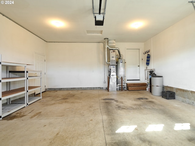 garage featuring strapped water heater and a garage door opener