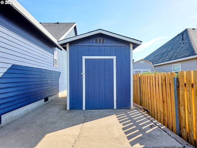 view of shed featuring fence