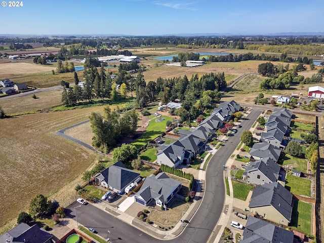 drone / aerial view featuring a residential view and a water view