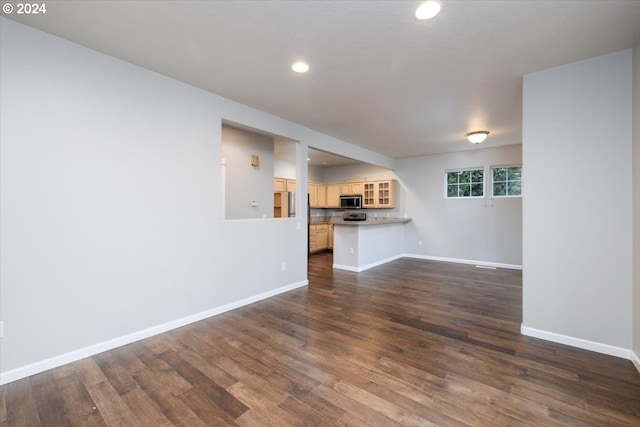 unfurnished living room with dark hardwood / wood-style floors