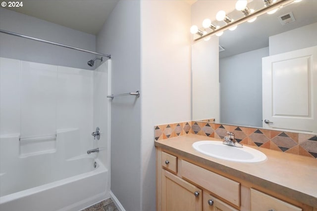 bathroom with decorative backsplash, shower / bathtub combination, and vanity