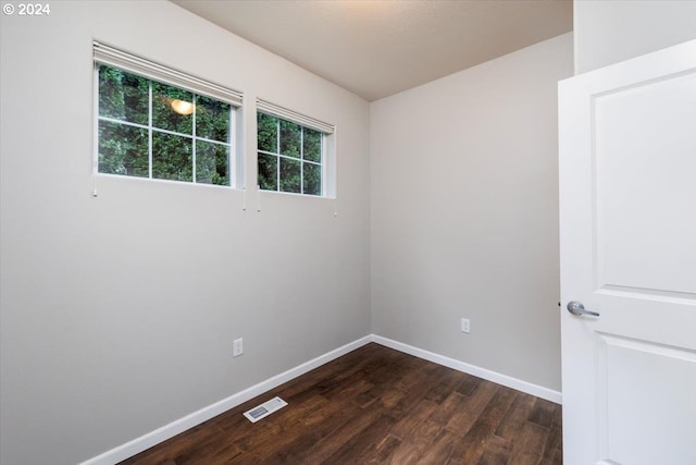 empty room with dark wood-type flooring