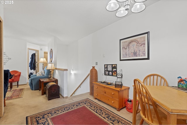 carpeted dining space featuring a notable chandelier