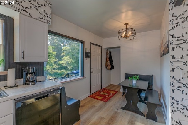 interior space featuring an inviting chandelier, baseboards, and light wood-style floors