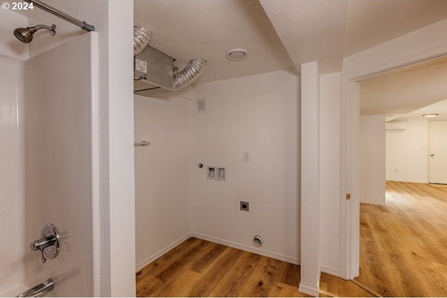 laundry area featuring laundry area, electric dryer hookup, light wood-style floors, and washer hookup