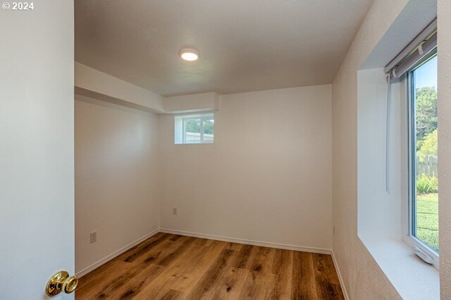 empty room with baseboards and wood finished floors