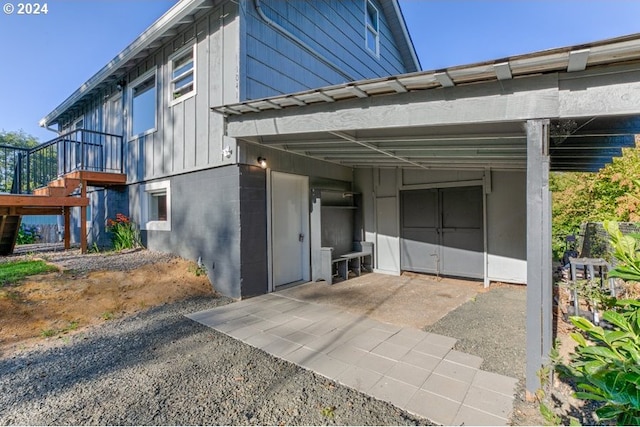 view of side of home featuring stairway