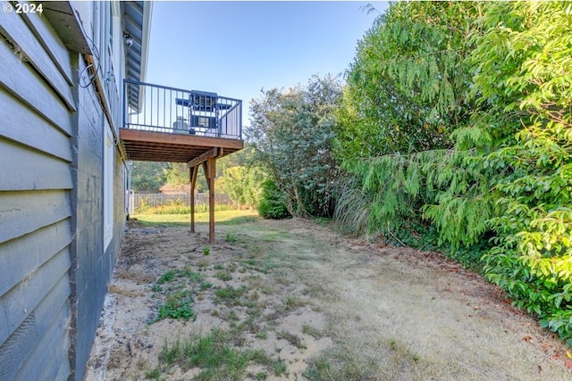 view of yard with a deck and fence