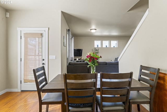 dining space with light hardwood / wood-style floors