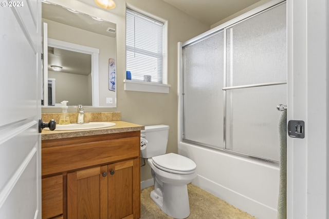 full bathroom with shower / bath combination with glass door, vanity, and toilet