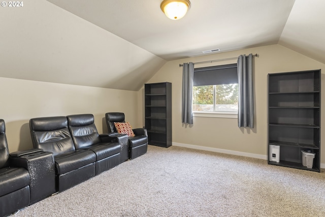 home theater featuring carpet and vaulted ceiling