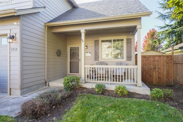 property entrance with a garage and covered porch