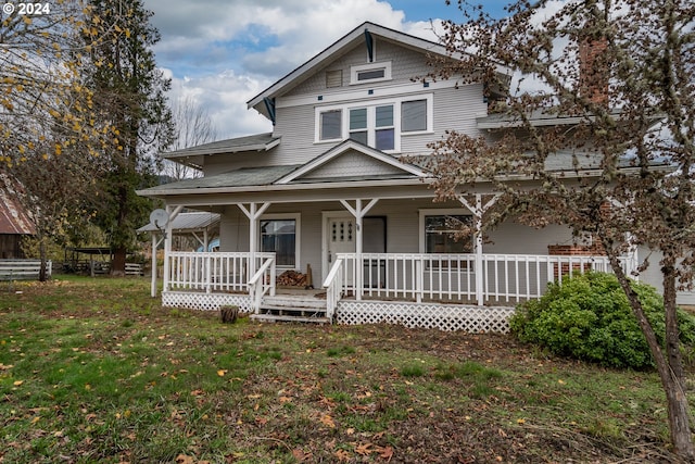 view of front of house with a porch and a front lawn