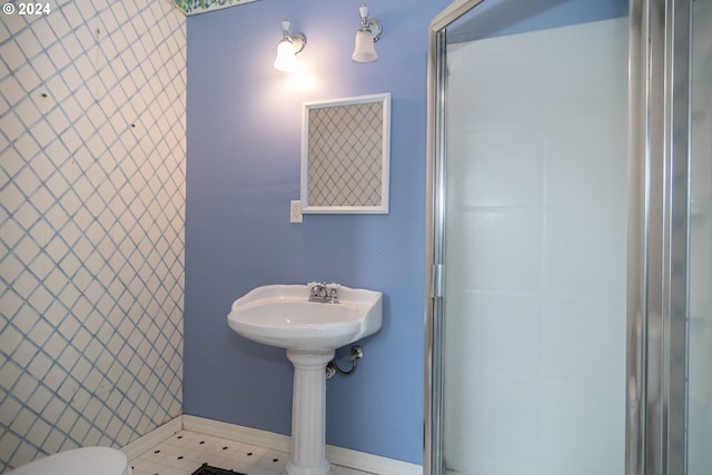 bathroom featuring a shower and baseboards