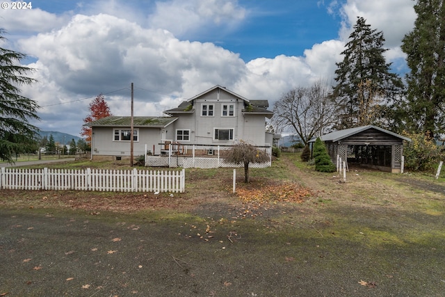 view of front of property featuring fence and a wooden deck