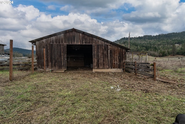 view of pole building featuring a rural view and fence