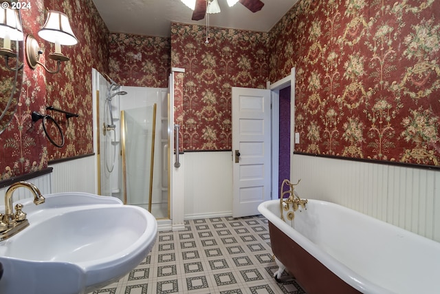 full bathroom with wallpapered walls and wainscoting