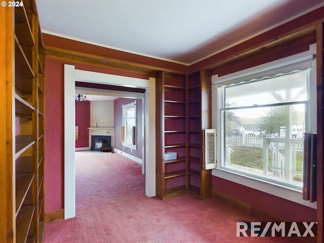 hallway featuring carpet, baseboards, and ornamental molding