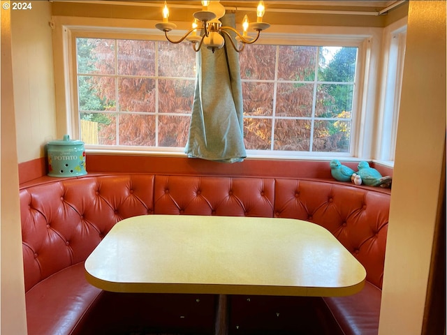 dining space featuring breakfast area and a notable chandelier