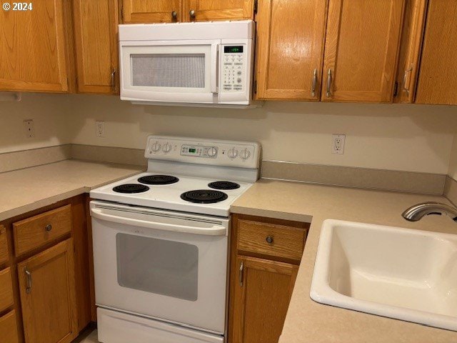 kitchen with sink and white appliances