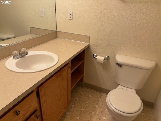 bathroom featuring vanity, toilet, and tile patterned floors