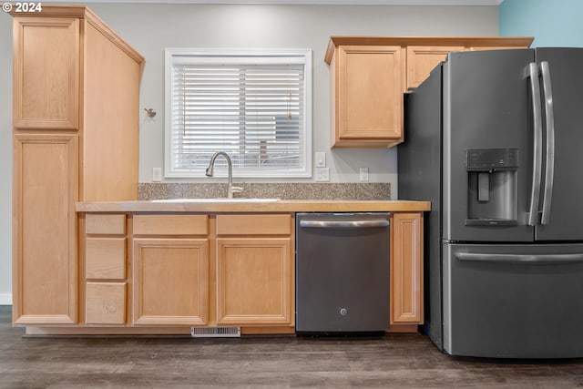 kitchen with sink, dark hardwood / wood-style flooring, light brown cabinets, and appliances with stainless steel finishes