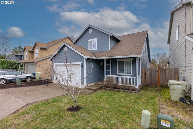 view of front of property with a garage, covered porch, and a front yard